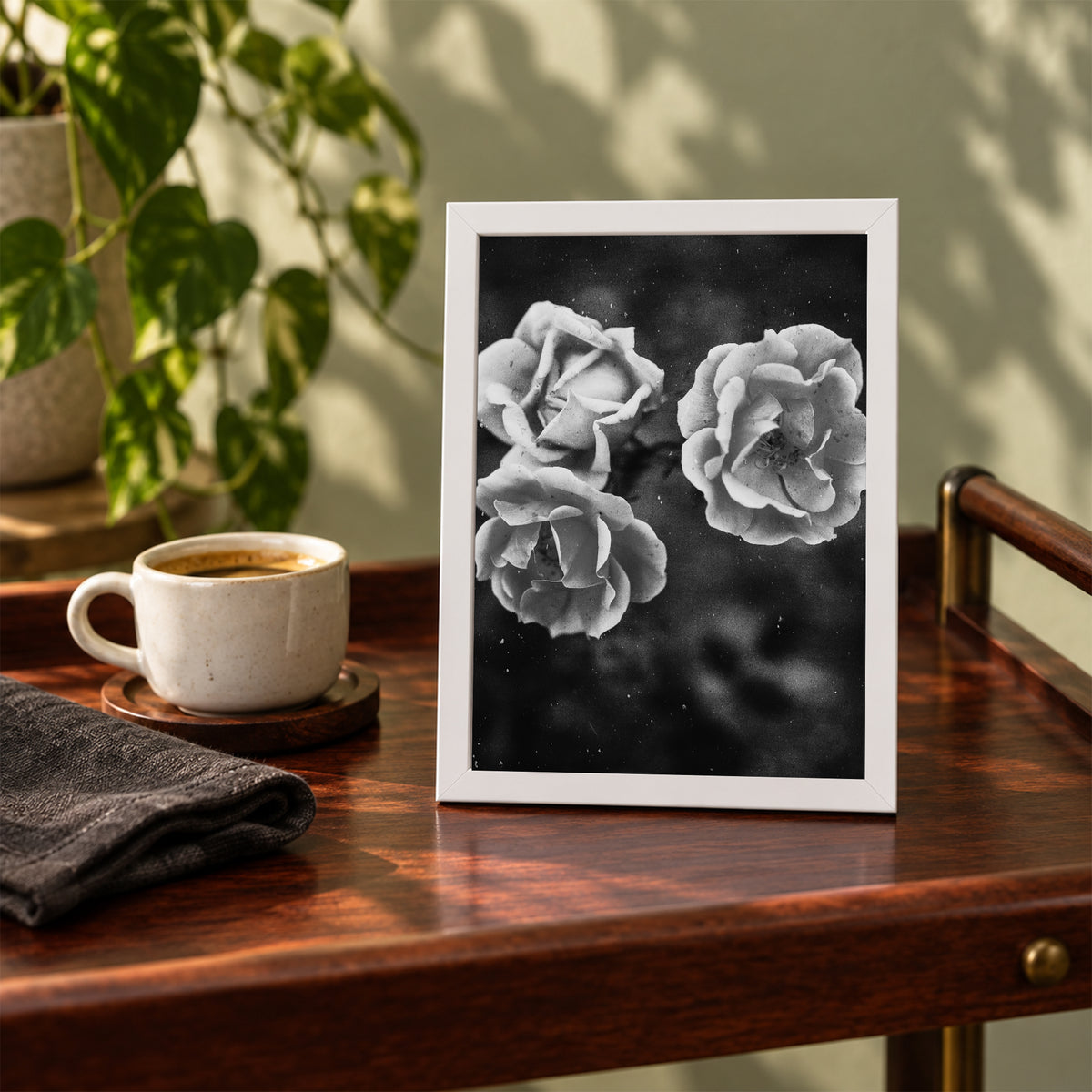 Duet Rose ︱ In Noir, 5×7 inch print shown in a styled room mockup. Two light roses blooming against a dark background in black and white. Frame shown for styling; print sold unframed.
