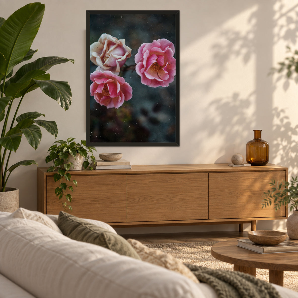 Duet Rose ︱ In Vibrant, 24×36 inch print shown in a styled room mockup. Two pink roses blooming beside a pale cream rose against a dark green background. Frame shown for styling; print sold unframed.
