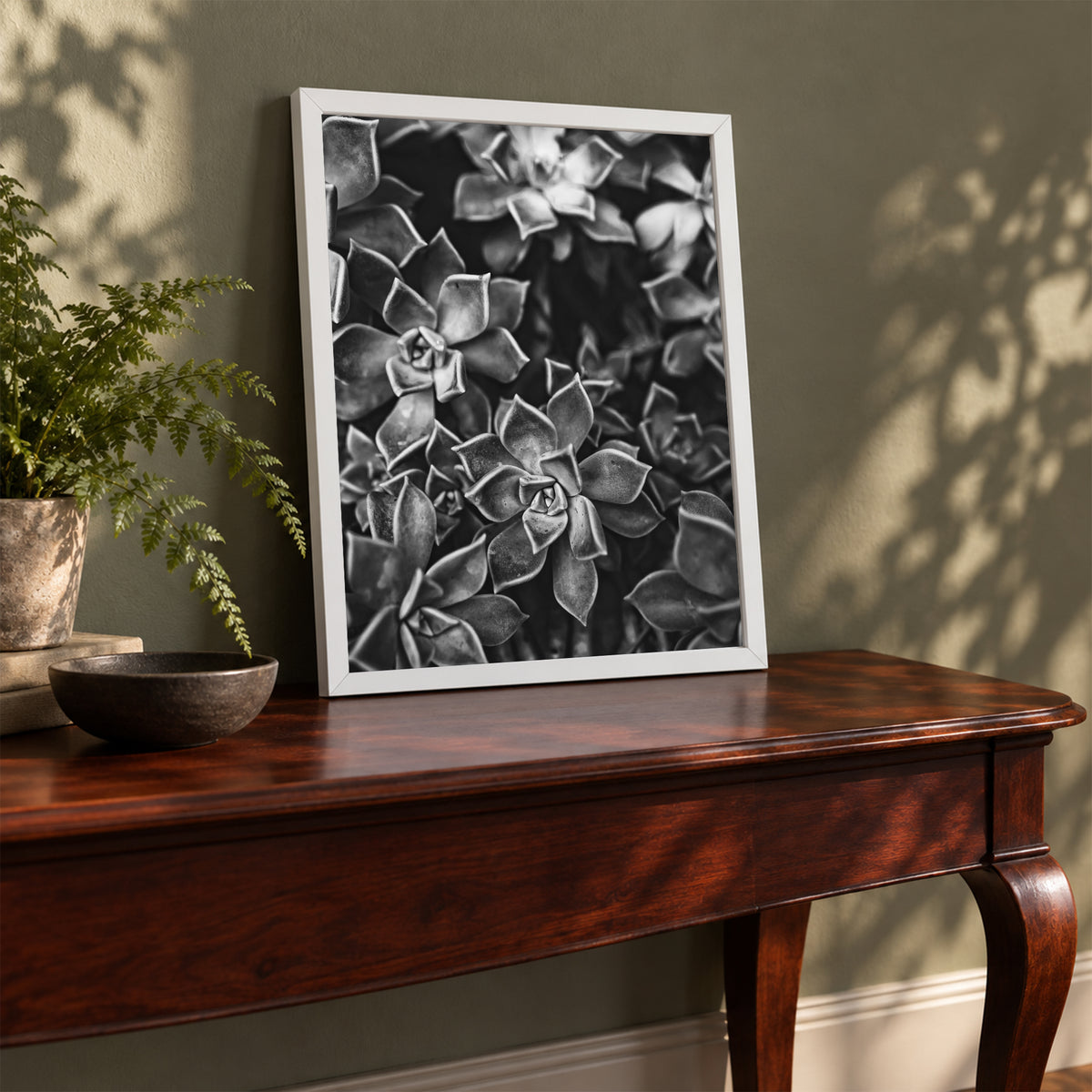Ghost Plant Succulent I ︱ In Noir, 8×10 inch print shown in a styled room mockup. Dense cluster of succulent rosettes rendered in high-contrast black and white. Frame shown for styling; print sold unframed.
