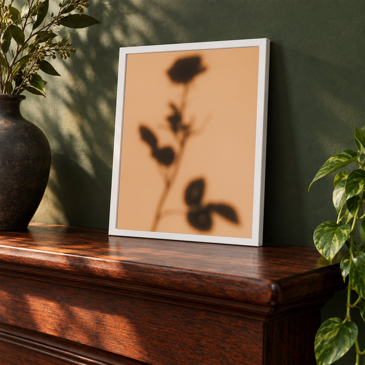 Shadow of Duet, 8×10 inch print shown in a styled room mockup. Soft shadow of a rose stem cast across a warm peach background. Frame shown for styling; print sold unframed.